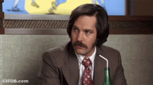 A Man With A Mustache Is Drinking Through A Straw . GIF
