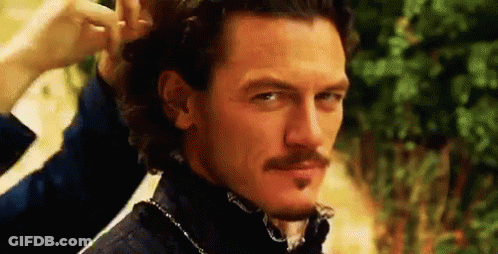 A Man With A Mustache Is Getting His Hair Done . GIF