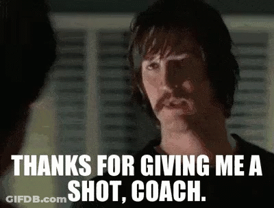 A Man With A Mustache Is Giving A Shot To Another Man . GIF