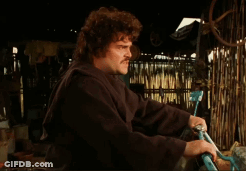 A Man With A Mustache Is Holding A Bicycle In His Hands GIF
