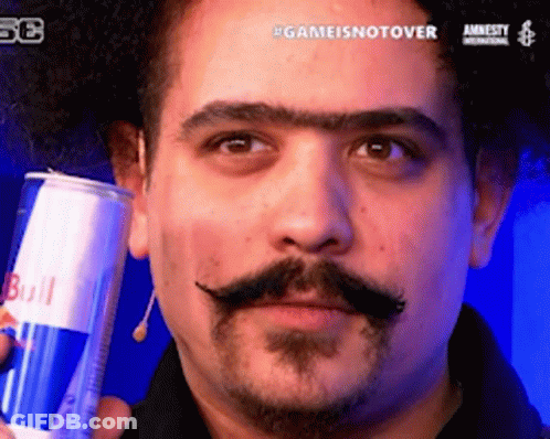 A Man With A Mustache Is Holding A Can Of Redbull GIF