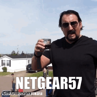 A Man With A Mustache Is Holding A Glass With The Words Netgear57 Written On The Bottom GIF