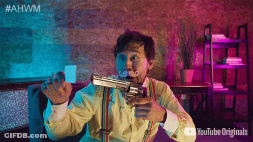 A Man With A Mustache Is Holding A Gun In Front Of A Sign That Says Youtube Originals GIF