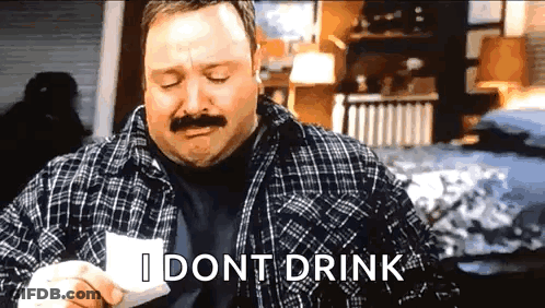 A Man With A Mustache Is Holding A Piece Of Paper And Says I Dont Drink . GIF
