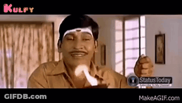 A Man With A Mustache Is Holding A Piece Of Paper In His Hand And Making A Funny Face . GIF