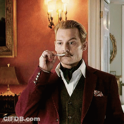 A Man With A Mustache Is Holding A Spoon In His Mouth And The Name Johnny Depp Is On The Bottom GIF