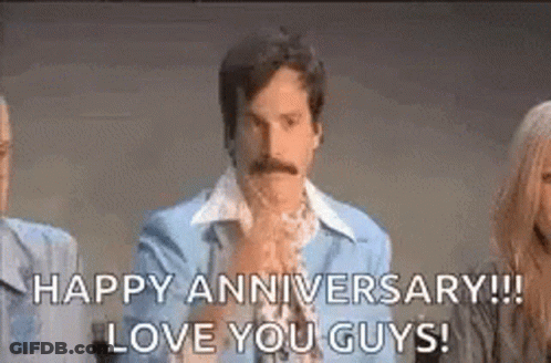 A Man With A Mustache Is Holding His Hands Together And Saying `` Happy Anniversary ! Love You Guys ! '' . GIF