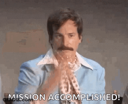 A Man With A Mustache Is Holding His Hands Together And Saying Mission Accomplished ! GIF