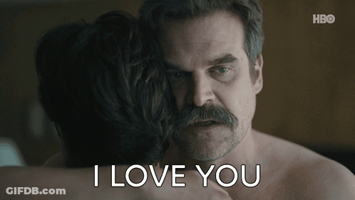 A Man With A Mustache Is Hugging A Woman With The Words I Love You Written Below Him GIF
