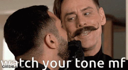 A Man With A Mustache Is Kissing Another Man On The Cheek With The Words " Watch Your Tone Mf " Below Him GIF