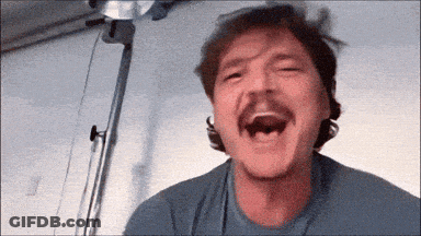 A Man With A Mustache Is Laughing While Wearing A Blue Shirt GIF