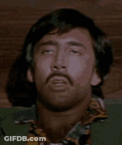 A Man With A Mustache Is Laying Down With His Eyes Closed And His Head Is Visible . GIF