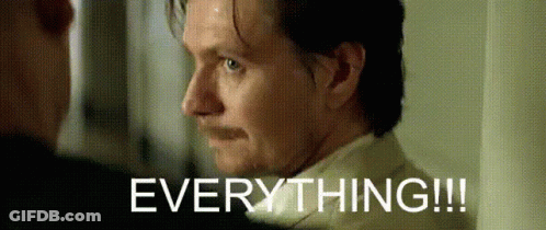 A Man With A Mustache Is Looking At Another Man With The Words Everything Written Above Him GIF