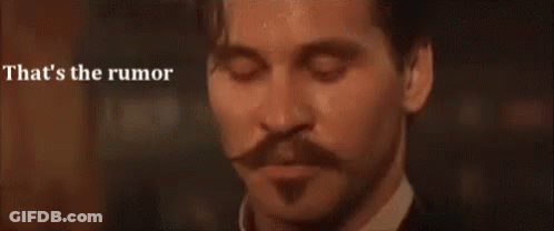 A Man With A Mustache Is Looking Down With His Eyes Closed And The Words `` That 'S The Rumor '' Behind Him . GIF