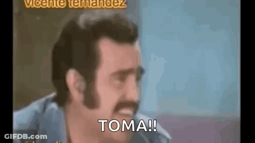A Man With A Mustache Is Making A Funny Face And Says `` Toma '' . GIF
