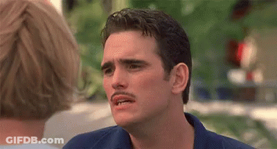 A Man With A Mustache Is Making A Funny Face In Front Of A Woman . GIF