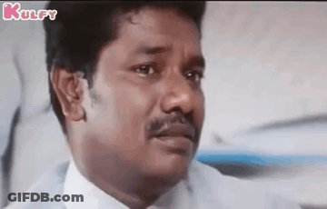 A Man With A Mustache Is Making A Funny Face While Sitting In A Chair . GIF