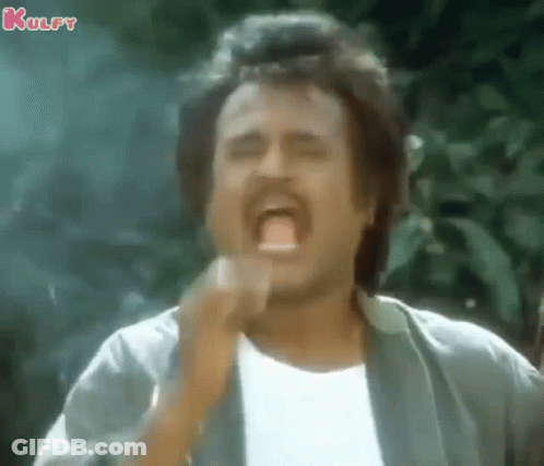 A Man With A Mustache Is Making A Funny Face With His Mouth Open And His Hand In His Mouth . GIF