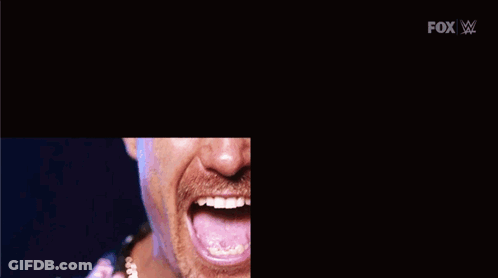 A Man With A Mustache Is Making A Funny Face With His Mouth Open GIF