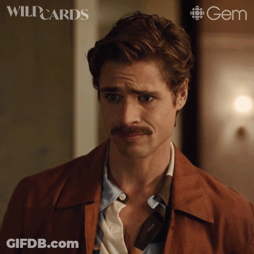 A Man With A Mustache Is On A Poster For Wild Cards GIF