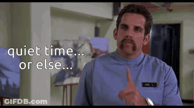 A Man With A Mustache Is Pointing At The Camera With The Words Quiet Time Or Else Behind Him .. GIF