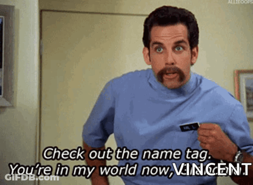 A Man With A Mustache Is Saying Check Out The Name Tag You 'Re In My World Now GIF