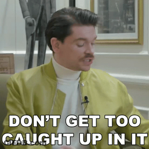 A Man With A Mustache Is Saying " Don 'T Get Too Caught Up In It " GIF