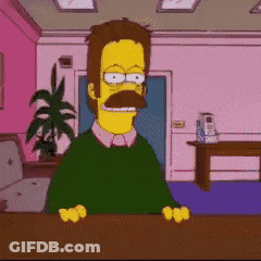 A Man With A Mustache Is Sitting At A Desk GIF