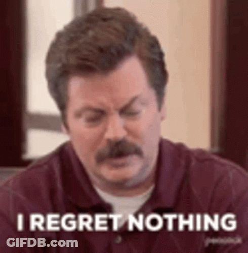 A Man With A Mustache Is Sitting At A Table With His Eyes Closed And Saying `` I Regret Nothing '' . GIF
