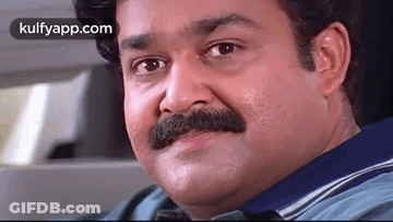 A Man With A Mustache Is Sitting In A Car . GIF