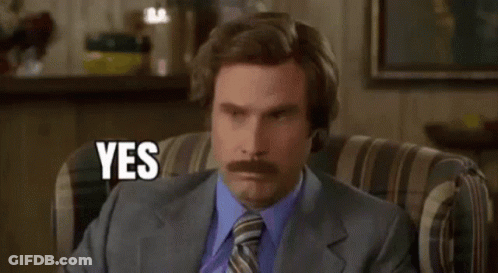 A Man With A Mustache Is Sitting In A Chair And Saying Yes . GIF