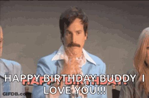 A Man With A Mustache Is Sitting In Front Of A Group Of People And Says Happy Birthday Buddy I Love You !!! GIF