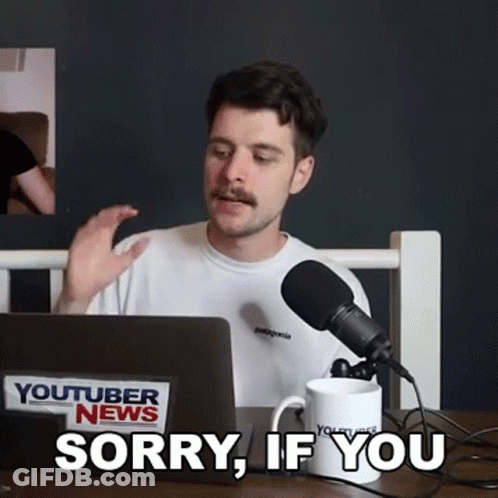 A Man With A Mustache Is Sitting In Front Of A Laptop Computer And A Microphone And Says Sorry If You GIF