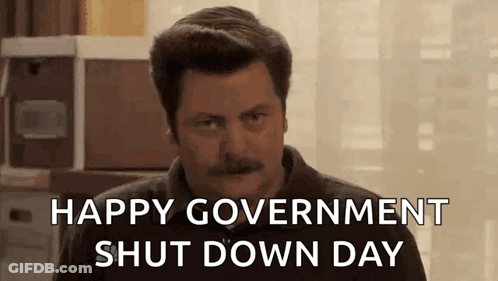 A Man With A Mustache Is Sitting In Front Of A Window And Says `` Happy Government Shut Down Day '' . GIF