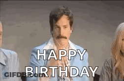 A Man With A Mustache Is Sitting Next To A Woman And Says `` Happy Birthday '' . GIF