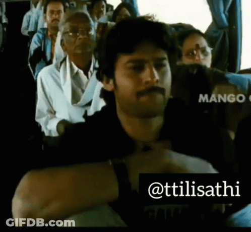 A Man With A Mustache Is Sitting On A Bus With Other People .. GIF