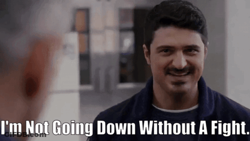 A Man With A Mustache Is Smiling And Says I 'M Not Going Down Without A Fight GIF