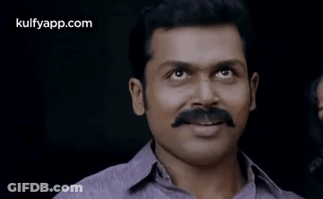 A Man With A Mustache Is Smiling For The Camera . GIF