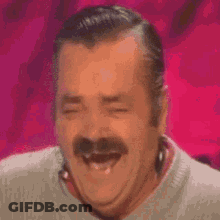 A Man With A Mustache Is Smiling With His Eyes Closed . GIF