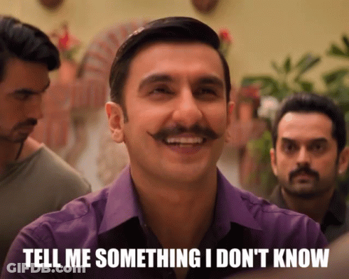 A Man With A Mustache Is Smiling With The Words Tell Me Something I Don 'T Know Below Him GIF