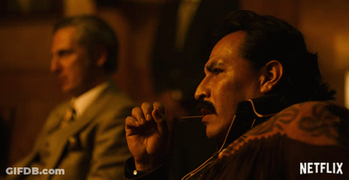 A Man With A Mustache Is Smoking A Cigar With A Netflix Logo In The Corner GIF