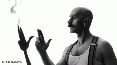 A Man With A Mustache Is Smoking A Cigarette GIF