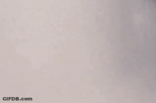 A Man With A Mustache Is Standing In A Bathtub With Smoke Coming Out Of His Nose . GIF