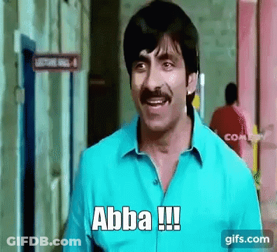 A Man With A Mustache Is Standing In Front Of A Building And Says Abba !!! GIF