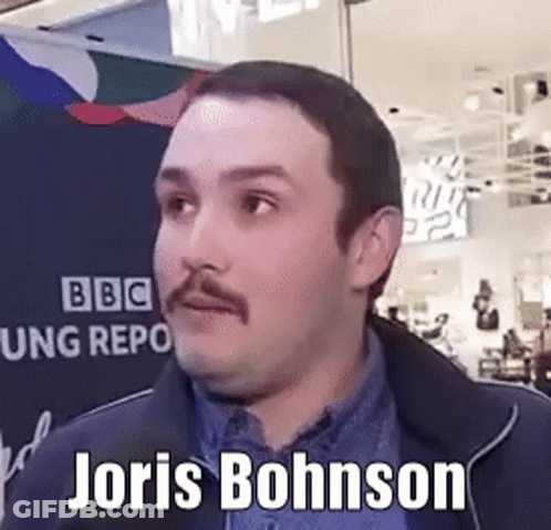 A Man With A Mustache Is Standing In Front Of A Sign That Says Joris Bohnson On It . GIF