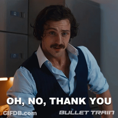 A Man With A Mustache Is Standing In Front Of A Sign That Says Oh No Thank You Bullet Train GIF