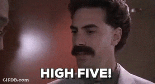 A Man With A Mustache Is Standing In Front Of A Wall And Says `` High Five '' . GIF