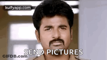 A Man With A Mustache Is Standing In Front Of A Window And Saying `` Send Pictures '' . GIF