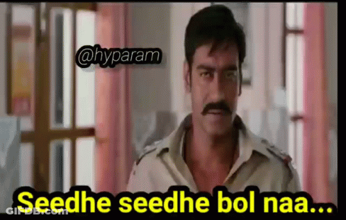 A Man With A Mustache Is Standing In Front Of A Window With A Caption That Says Seedhe Seedhe Bol Naa . GIF