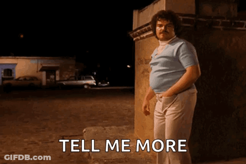 A Man With A Mustache Is Standing Next To A Wall With The Words Tell Me More Below Him GIF